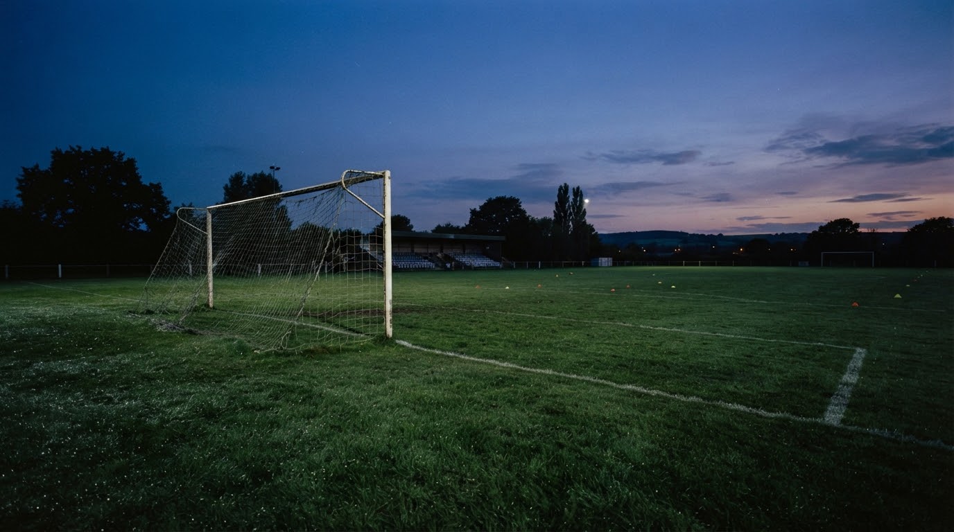 An empty pitch at dusk, goal with no players